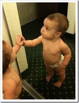 Baby wondering about mirror