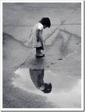 Little girl reflected in water