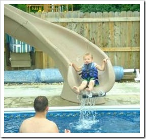 Boy coming down water slide
