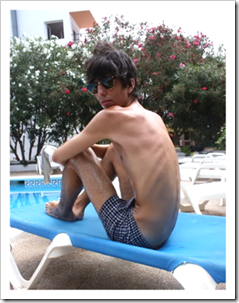 ANorexic boy at the pool