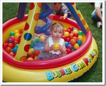 Little girl in a pool filled with balls