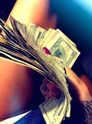 Woman holding wad of money