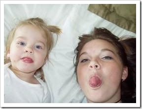 Baby and mum sticking tongues out