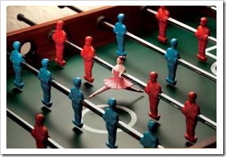 Foosball table with a ballerina as one of the players