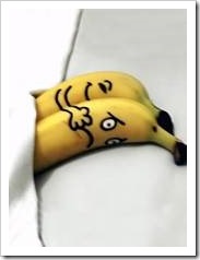 A happy bananna is hugging a sad banana.