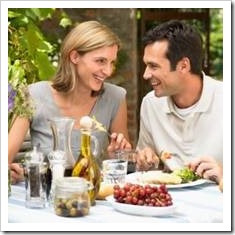 Man and Woman eating a meal in a vinyard