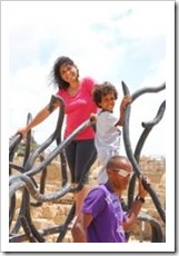 Woman and child climbing a sculpture