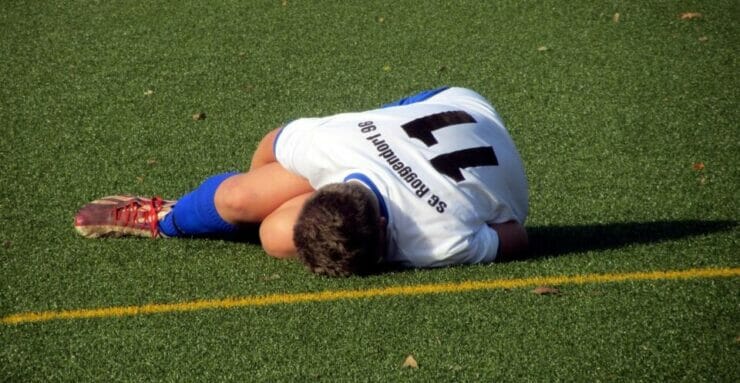 Boy lying on a football field