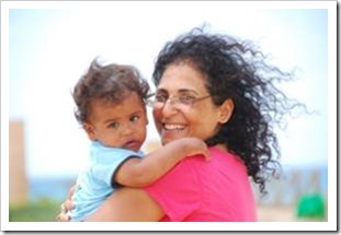 Woman hugging a baby and smiling