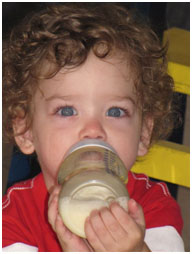 Baby drinking baby food from a bottle