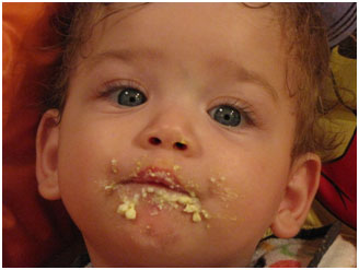 Baby with baby food on his face