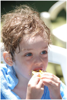 Boy eating corn
