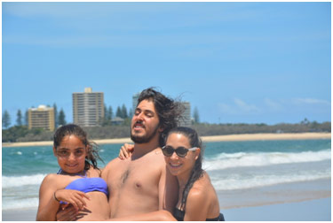 Three grown children on the beach