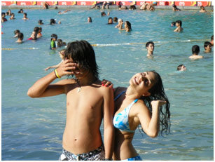 Two teens posing in a pool