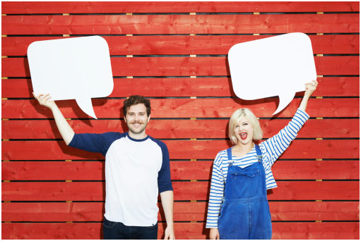 Man and woman holding up speech bubbles