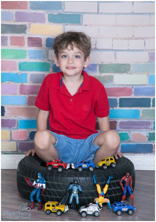 Boy sitting in a car tyre