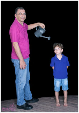 Parent watering a child