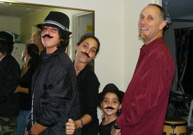 Father and kids wearing fake moustaches