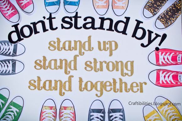 Circle of sneakers with the words "Don't stand by! Stand up, stand strong, stand together"