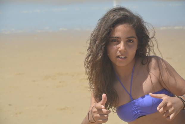 Teenage girl in cool pose on the beach