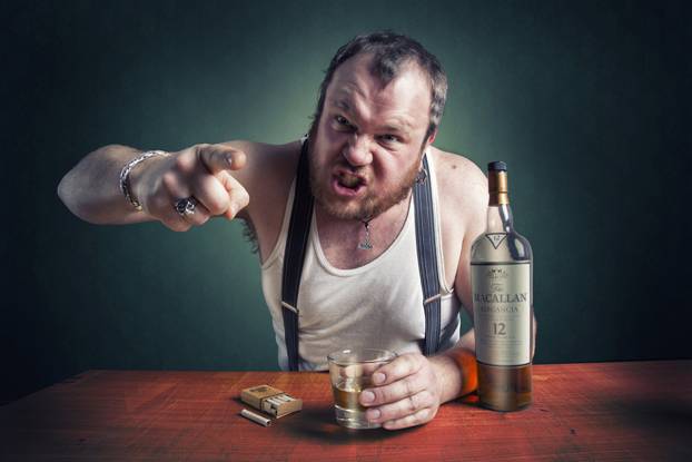 Angry man drinking alcohol