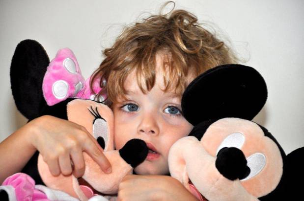 Baby with Mickey and Minnie Mouse dolls