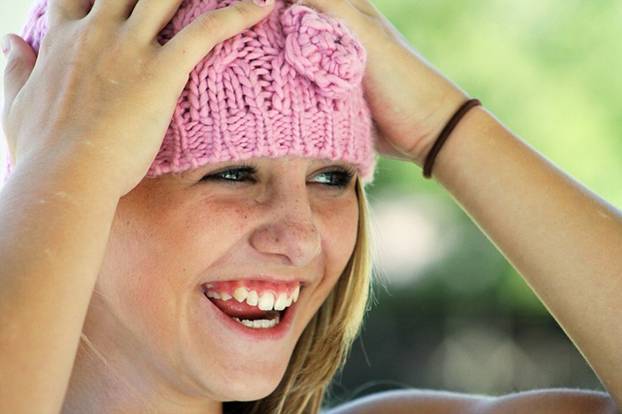 Teenage in a beanie girl smiling happily