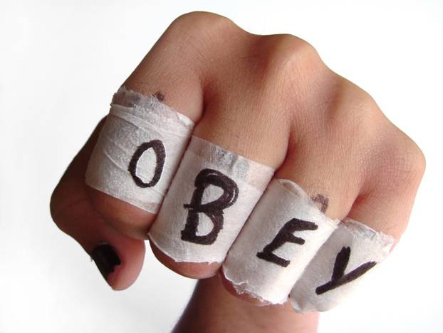OBEY written on knuckles