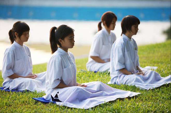 Young Buddhist girls meditating