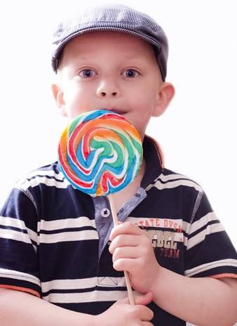 Boy holding a large round candy