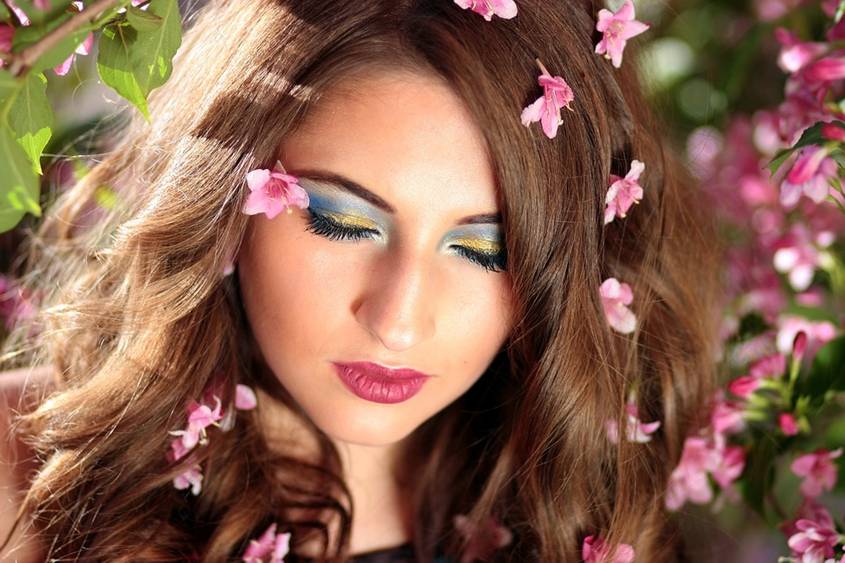 A woman with her eyes closed and flowers in her hair