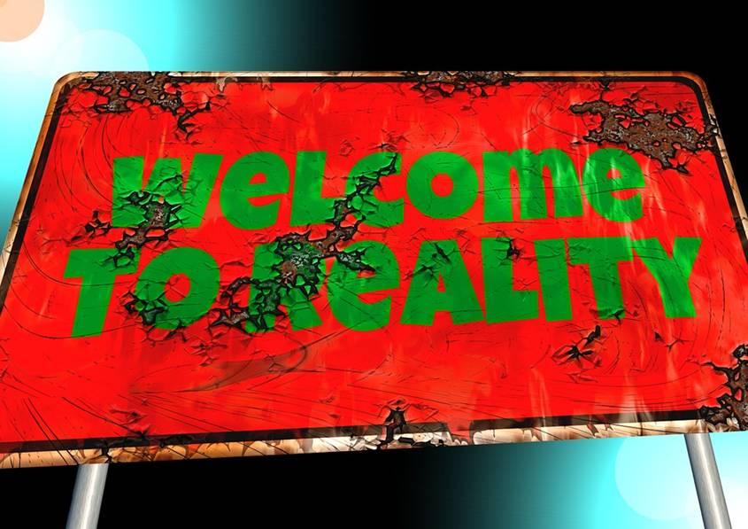 Rusty sign saying Welcome to Reality