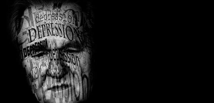 The word depression projected onto a sad man's face