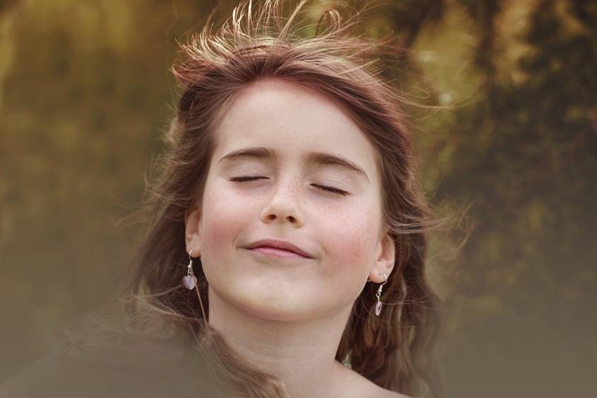 Teenage girl smiling with her eyes closed