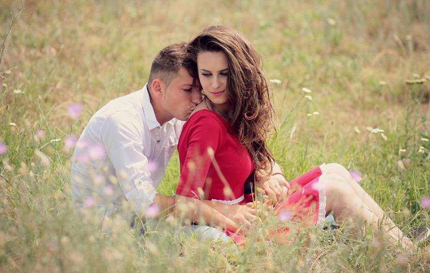 Couple sitting in a field