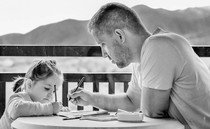 Father, daughter and a workbook