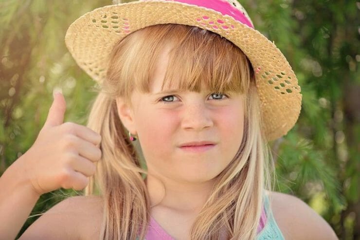 Girl looking worried while giving the thumbs up