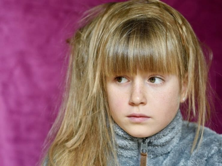 Girl with disheveled hair looking worried