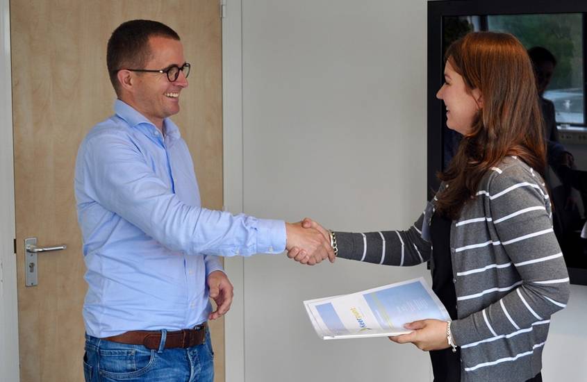 Man and woman shaking hands and smiling