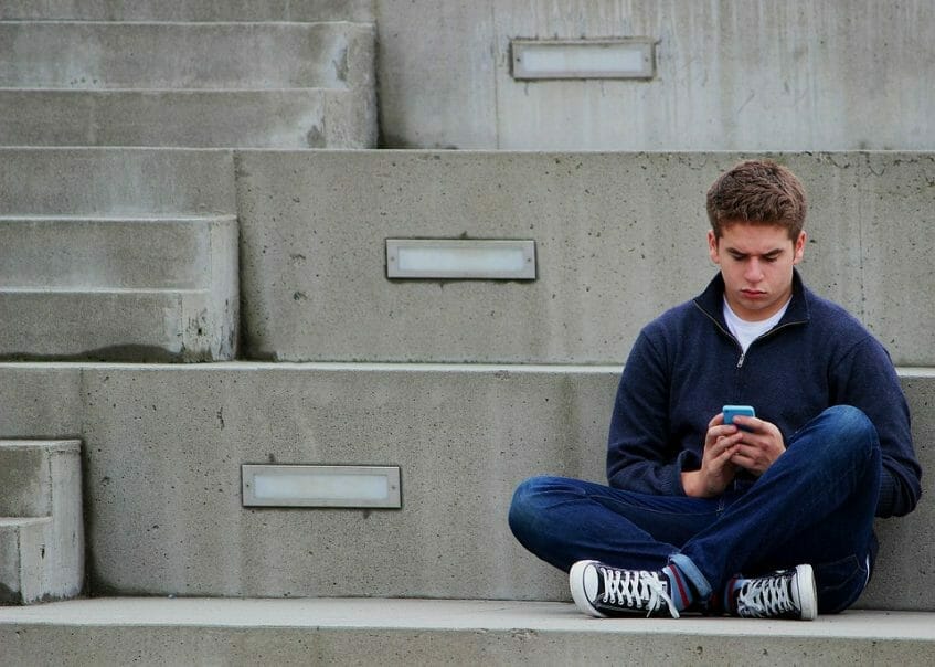 Teenage boy with his mobile phone