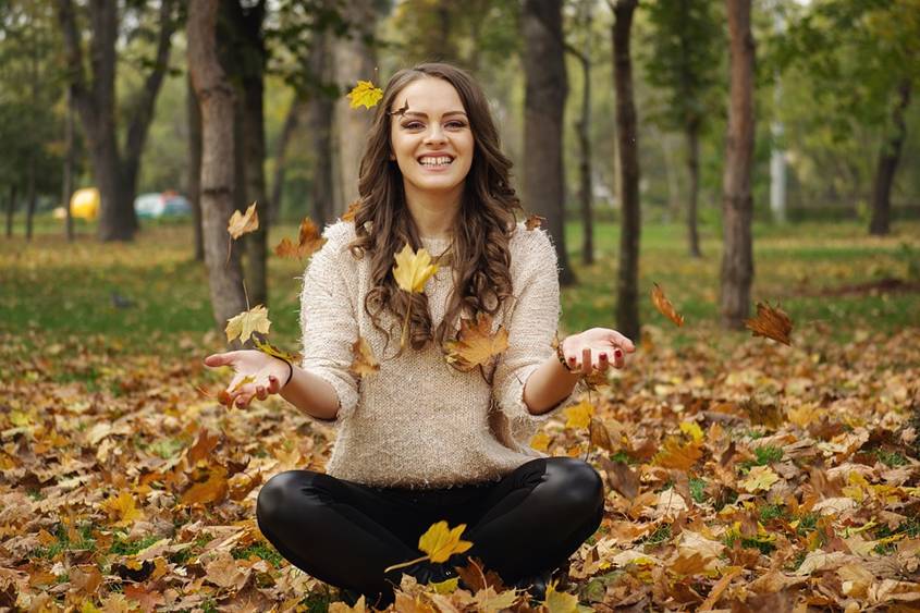 Happy woman sitting in a forest