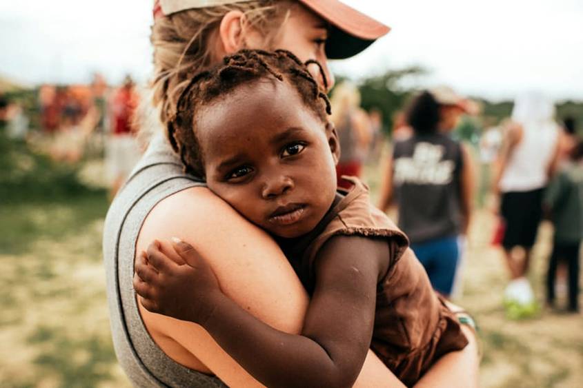 Woman holding African child