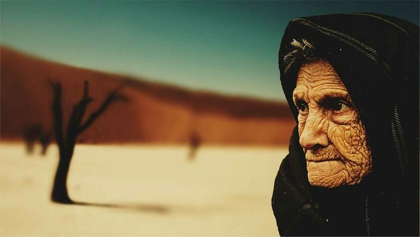 Old wrinkled woman in the desert