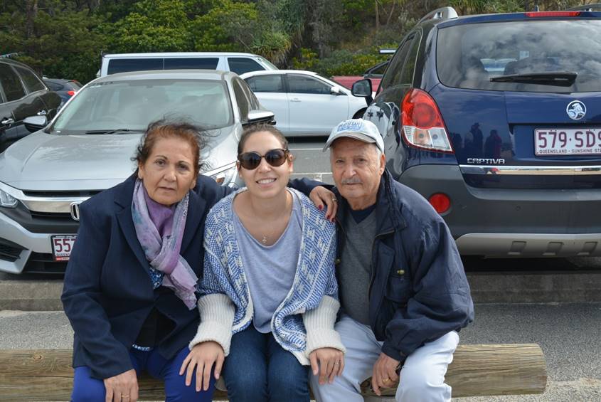 Grandparents and granddaughter on a park bench