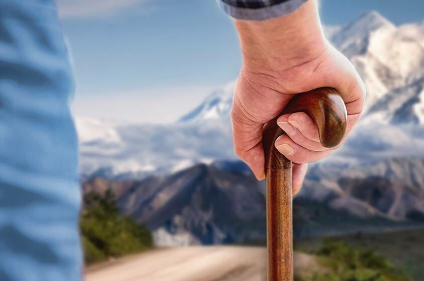 Old man's hand on a walking cane