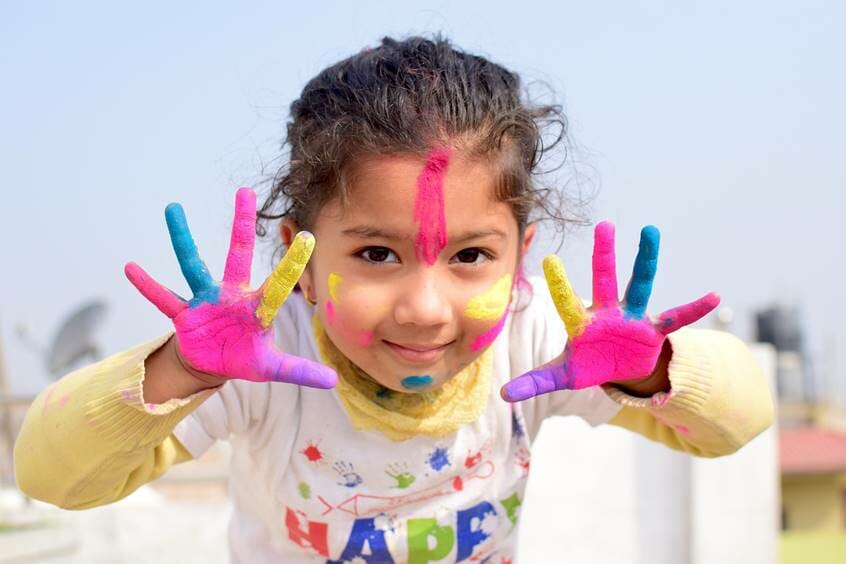 Girl with painted face and hands