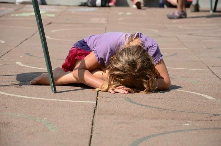 Autistic girl on the ground at school