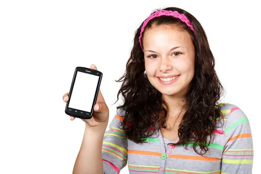 Teen girl holding up her mobile phone