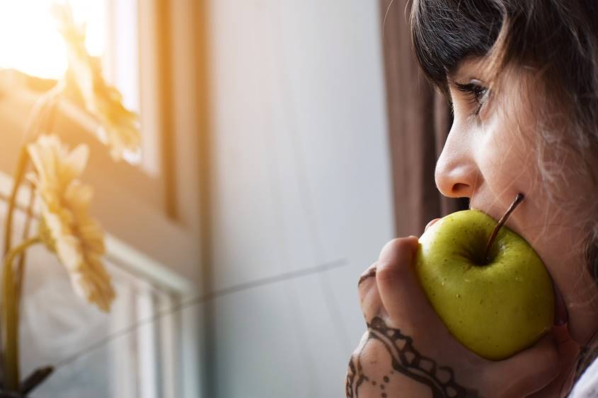 Girl biting into an apple