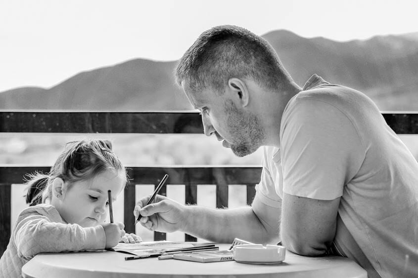 Father helping daughter with homework